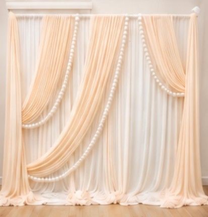 Draped backdrop rental in soft peach and white